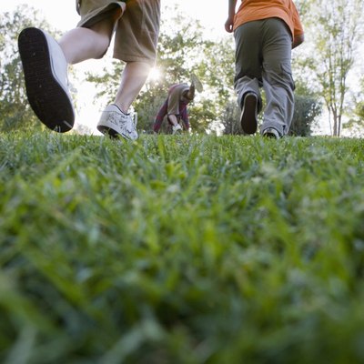 a group of young boys walking across grass
