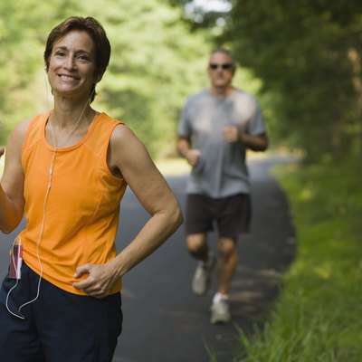 Smiling jogger with bottle of water