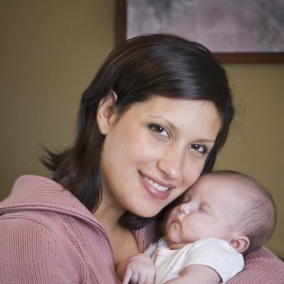 Hispanic mother hugging baby