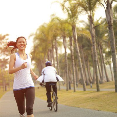 healthy lifetyle asian woman jogging at tropical park