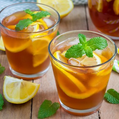 Refreshing homemade lemon iced tea on a wooden table