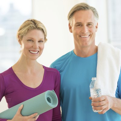 Couple With Exercise Mat; Water Bottle And Towel In Club