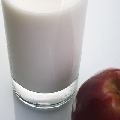 Glass of milk with an apple, studio shot