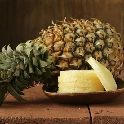 dessert pineapple sliced on a wooden plate