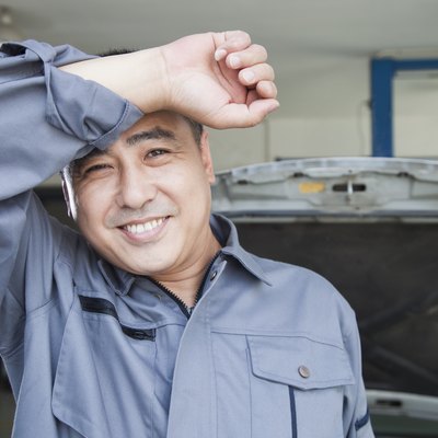 Auto Mechanic Wiping the Sweat Off His Brow