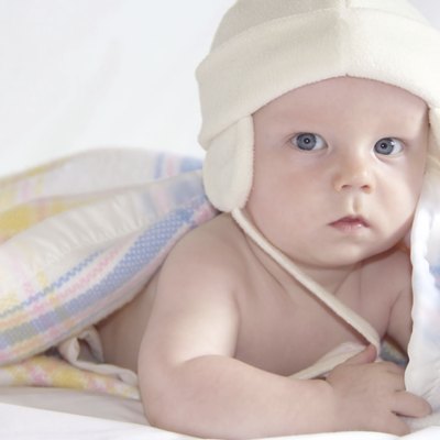 Cute tiny baby under worm blanket