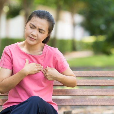 Woman has chest pain in the garden