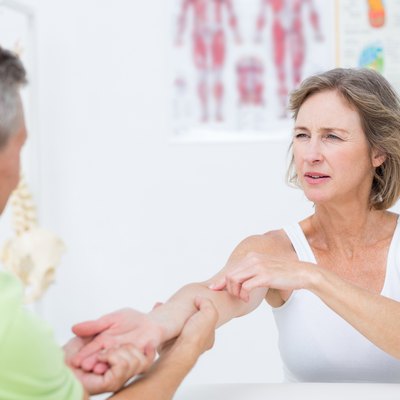 Doctor examining his patients arm
