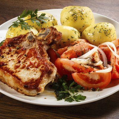 Pork chop, boiled potatoes and vegetables