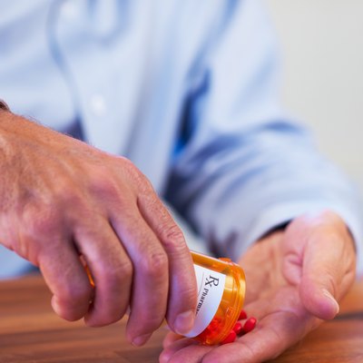 Patient pouring out RX pills into hand