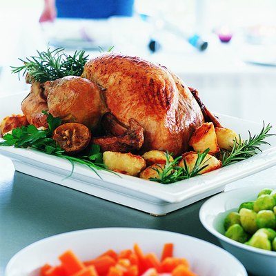 Roast Turkey and Vegetables with a Woman in the Background