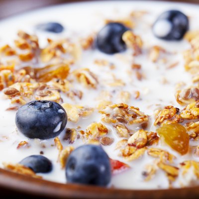 Healthy breakfast. Fresh granola, muesli with berries, honey and milk