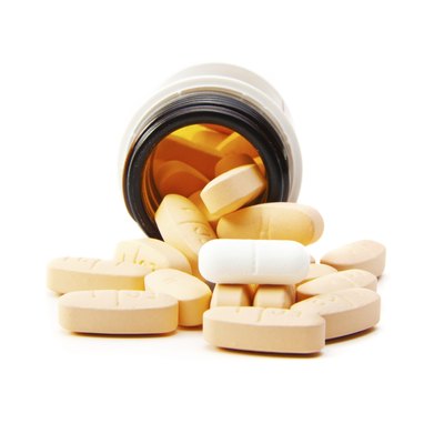 Overhead view of pills in plastic pot - isolated
