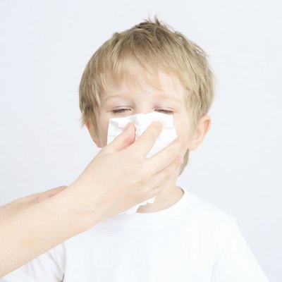 child blowing his nose
