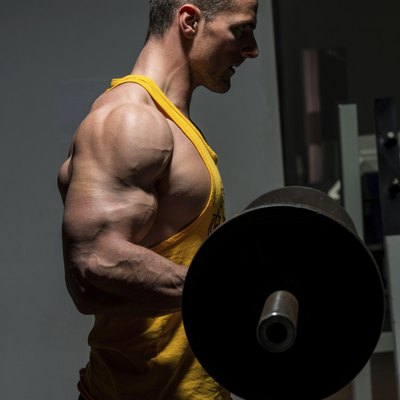young man doing heavy weight exercise for biceps