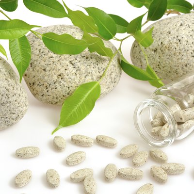 Herbal supplement pills spilling out of bottle – alternative medicine