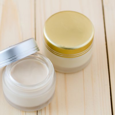Cream container on white background