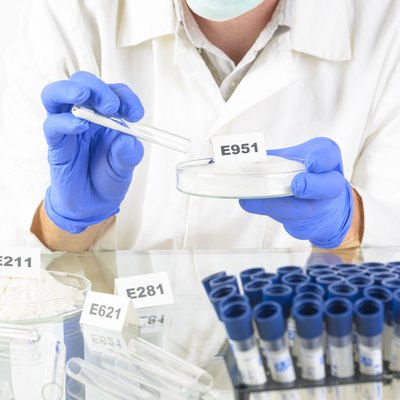 Researcher holding sweetener E951