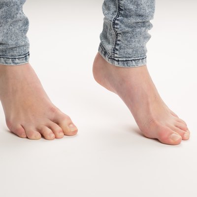 Two Bare Feet Standing TipToe On The Floor