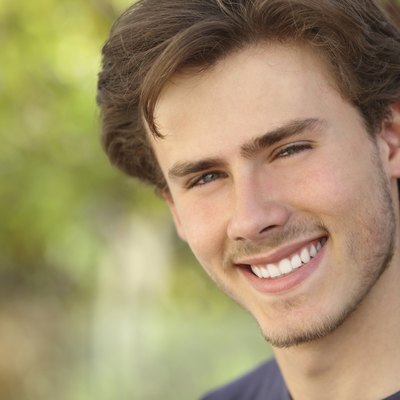 Handsome man face with a white perfect smile