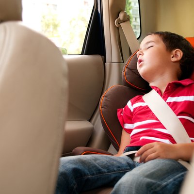 Litle boy sleeps in safe chair car