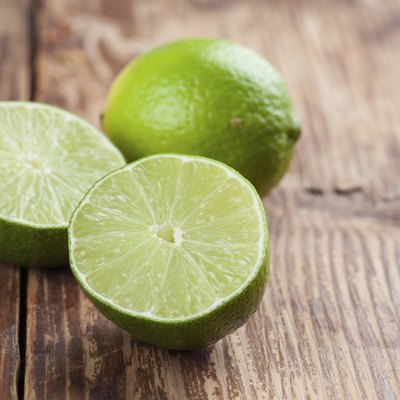 Limes on wooden background