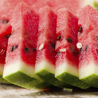 slices of watermelon on wooden table