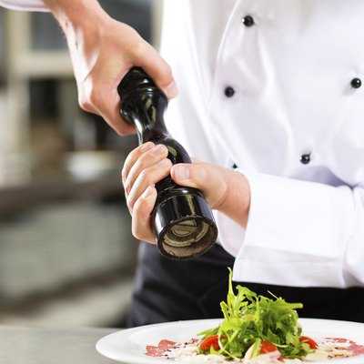 Chef in hotel or restaurant kitchen cooking