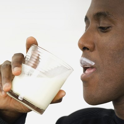 Man drinking milk and having a milk mustache, close-up