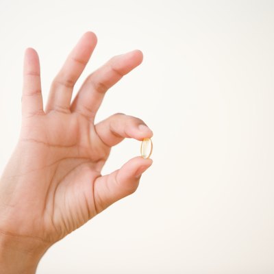 Close up of hand holding vitamin