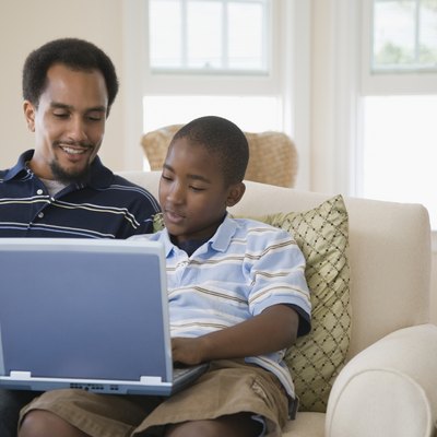 Young man and his son using a laptop