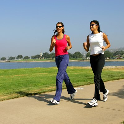 Two women jogging on the seafront.