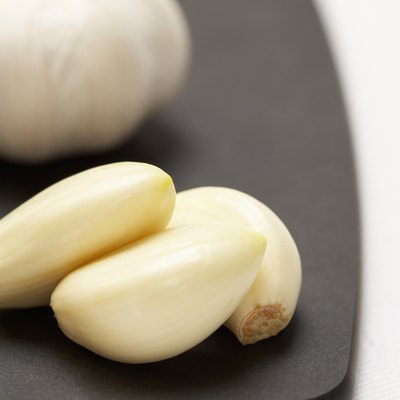 Garlic cloves and bulb on cutting board