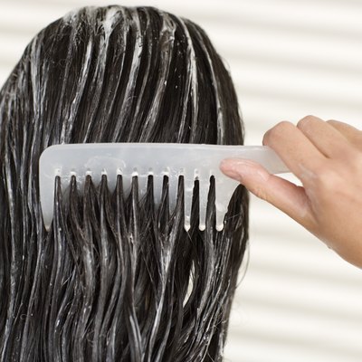 Woman combing her wet hair