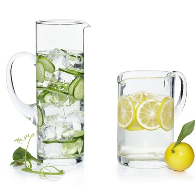 Pitchers of water with cucumber and lemon slices