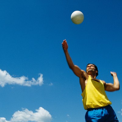 Man serving volleyball