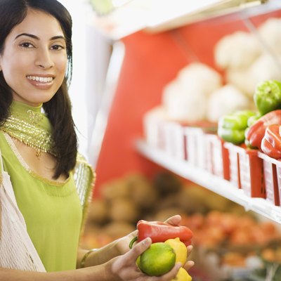 Woman grocery shopping for vegetables