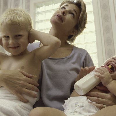 Low angle view of a mother holding her son and daughter