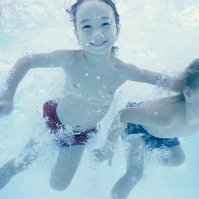 Two children swimming underwater