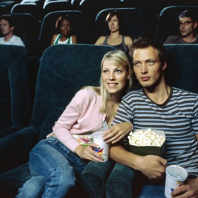 Young couple watching movie in a movie theatre
