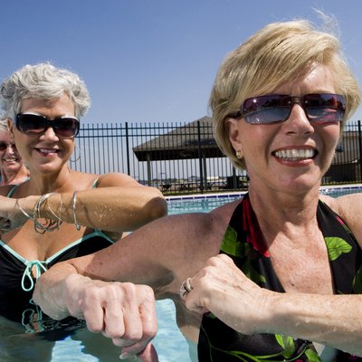 Cheerful senior women exercising in swimming pool
