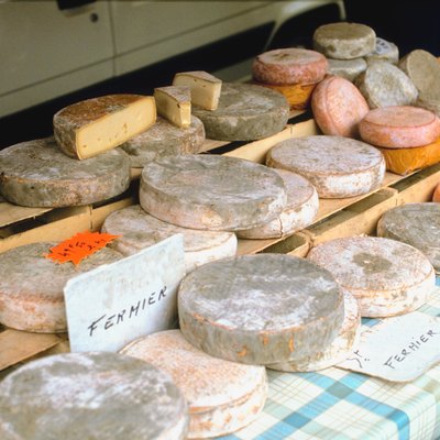 Assortment of cheese on table outdoors, Auvergne, France