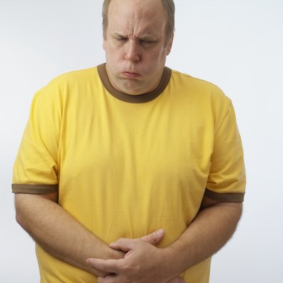 Man with hands on stomach, upper half,