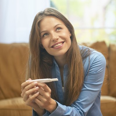 Woman holding home pregnancy test
