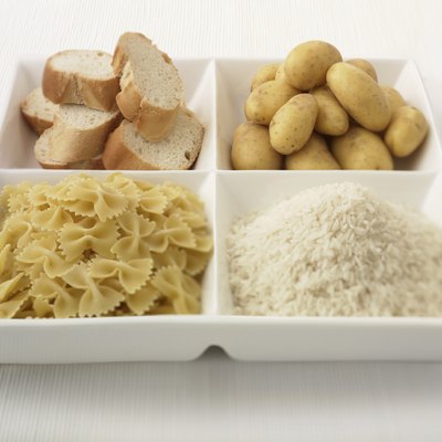 Close up of sectioned plate with bread, potatoes, rice and pasta