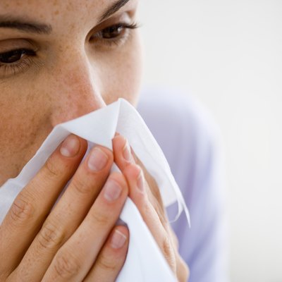 Woman blowing nose