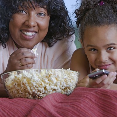 African mother and daughter eating popcorn