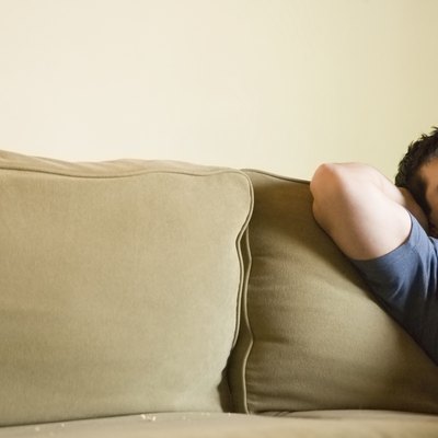 Mature man relaxing on sofa