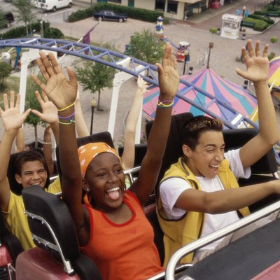 Group of teenagers riding a rollercoaster