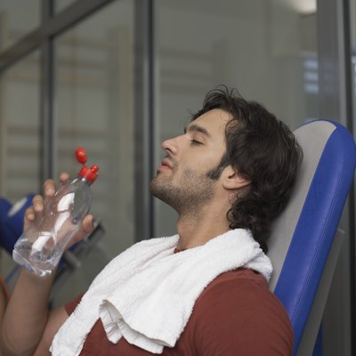 Man drinking water after exercising